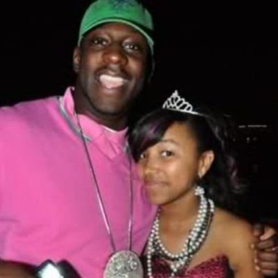 Zonnie Pullins with young Zonnique Pullins, his daughter, wearing a tiara and posing for a photo in an official gathering.